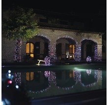 Casă de piatră cu grădină, iluminată cu un lanț luminos