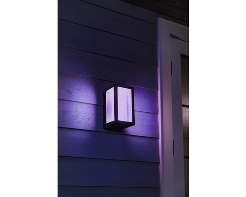 Lumină de perete exterioară pătrată cu iluminare pe un perete de lemn