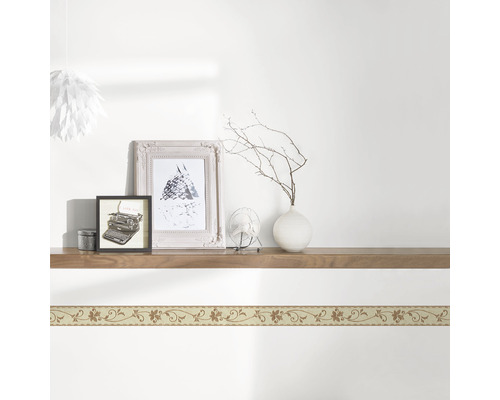 Perete cu bordură florală și decorațiuni pe o poliță de lemn