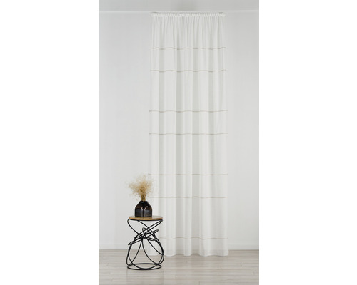 Șaluri decorative cu model în dungi în fața unui perete, lângă o măsuță laterală cu decorațiuni