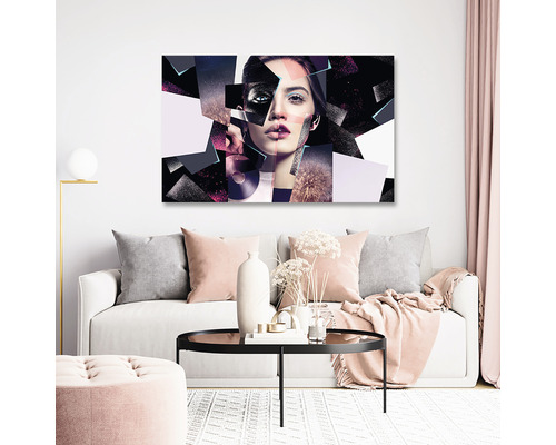 Living cu canapea și pictură murală cu chip de femeie în design geometric.