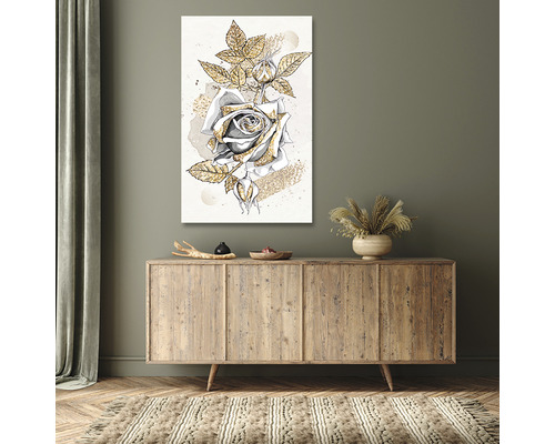 Tablou decorativ de perete cu motiv de trandafir deasupra unei comode din lemn într-un spațiu de locuit.