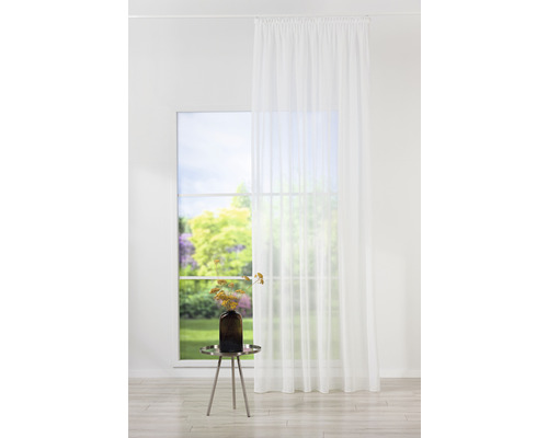 Cameră luminoasă cu fereastră, draperie transparentă și măsuță laterală