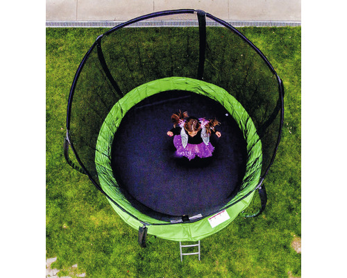 Vedere de sus a unei trambuline rotunde de grădină cu plasă de siguranță și o persoană pe ea.