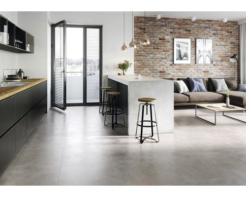 Living modern cu pardoseală cu gresie, chicinetă și perete din cărămidă