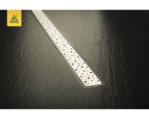 Canal de duș din oțel inoxidabil cu model punctat pe fundal de gresie închisă la culoare