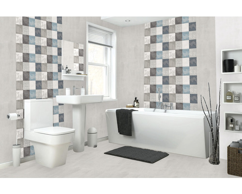 Baie luminoasă cu toaletă, chiuvetă și cadă în fața unui perete cu plăci pătrate