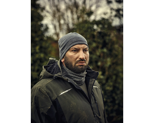 Bărbat cu căciulă și jachetă de lucru în aer liber