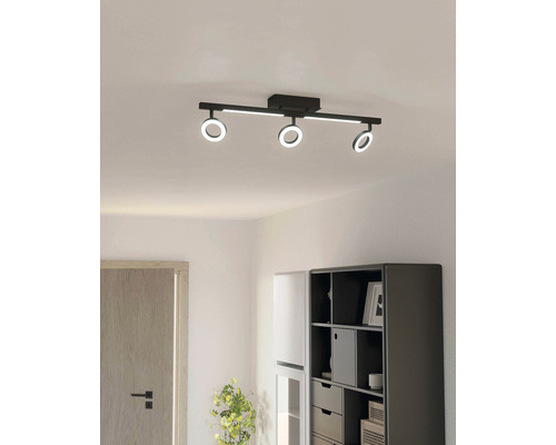 Plafoniere neagră cu trei inele LED într-o cameră luminoasă.