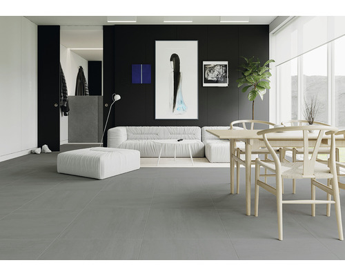 Living modern cu gresie gri, canapea și masă de sufragerie