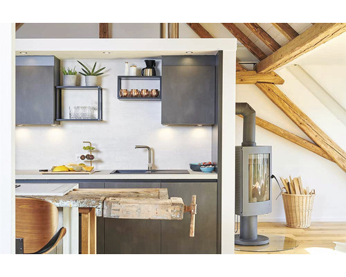 Bucătărie luminoasă cu dulapuri de bucătărie, chiuvetă, blat, raft și sobă pe lemne într-o casă cu tavan cu grinzi din lemn