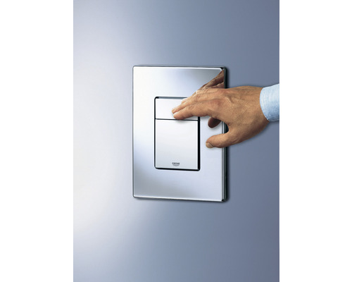 Placă de acționare Grohe cu mâna montată pe un perete