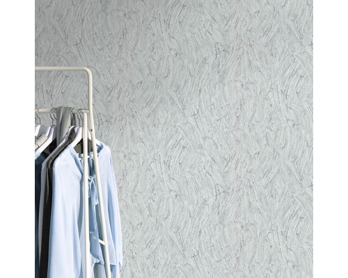 Prim-plan cu un tapet texturat cu suport pentru haine și articole de îmbrăcăminte în cameră
