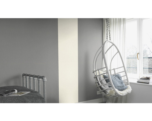 Dormitor cu decor de perete în gri și alb și fotoliu suspendat tip coș