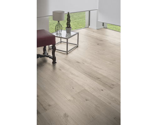 Cameră luminoasă cu podea din lemn, măsuță laterală și taburet.