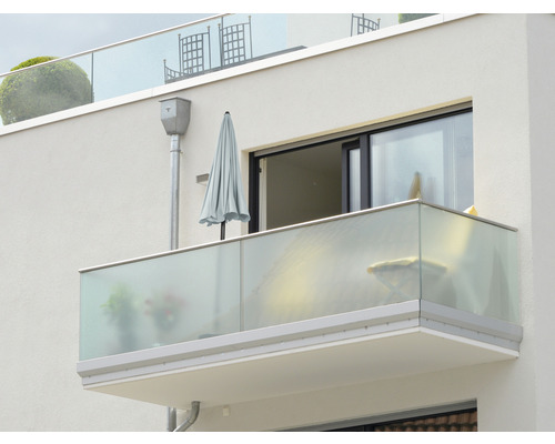 Vedere exterioară a unui balcon cu balustradă de sticlă și umbrelă de soare