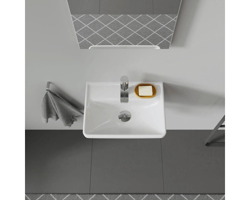 Vedere de sus a unei băi cu chiuvetă, robinet, oglindă, prosop și săpun