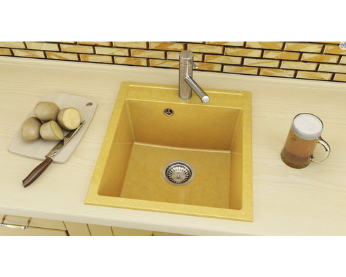 Chiuvetă de bucătărie cu robinet, tocător cu cartofi și cuțit și un pahar de bere