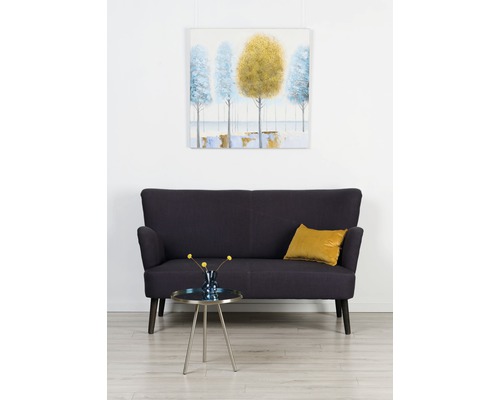 Scenă de sufragerie cu canapea bleumarin, măsuță laterală cu flori și imagine înrămată pe perete