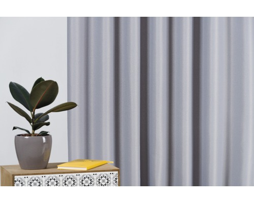 Cortină decorativă de fereastră și plantă de interior pe o masă