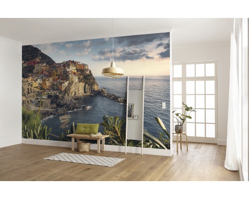 Cameră de zi cu fototapet cu un oraș de coastă pe o stâncă