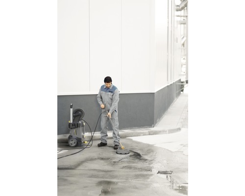 Bărbat curăță suprafața cu curățitor cu presiune și curățitor de suprafețe