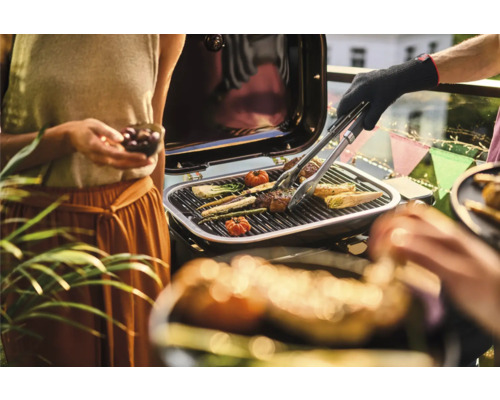 Persoane care fac grătar cu legume și carne pe un grătar.