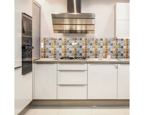 Bucătărie modernă cu dulapuri albe, hotă și placare cu motive florale.