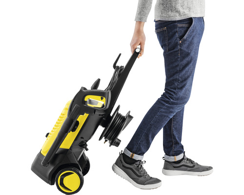 Aparat de curățat cu presiune galben, cu o persoană care îl trage