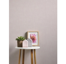 Scenă decorativă cu tapet floral, masă, plantă de interior și ramă foto
