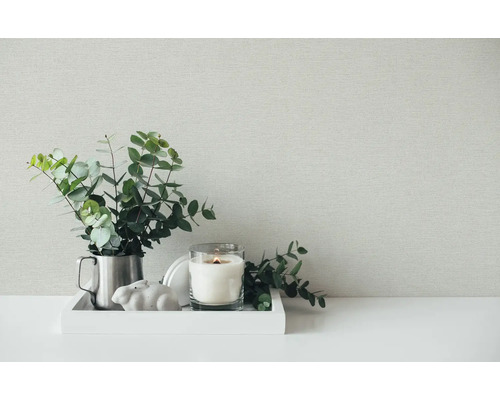 Scenă decorativă cu lumânare, plantă și decorațiuni pe o tavă