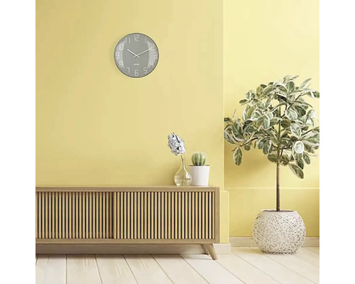 Cameră de zi cu bufet, plante de interior și un ceas de perete