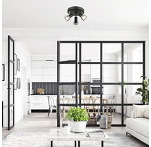 Scenă modernă de living cu plafonieră, separator de cameră și decor luminos.