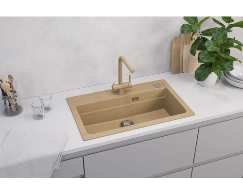 Chiuvetă cu robinet într-o bucătărie luminoasă.