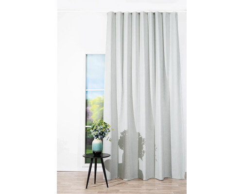 Vedere a camerei cu perdea la fereastră și măsuță laterală cu vază cu flori