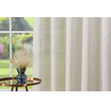 Cortină decorativă pentru fereastră cu aranjament de plante pe o măsuță