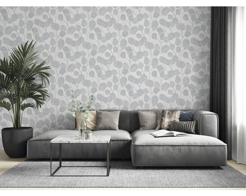 Cameră de zi cu canapea gri, plantă de interior și tapet cu model de frunze