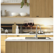 Scenă de bucătărie cu chiuvetă, robinet, pahare, veselă și elemente din lemn