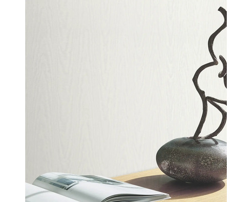 Tapetă deschisă la culoare cu aspect de lemn pe o decorațiune de masă cu o carte și o sculptură