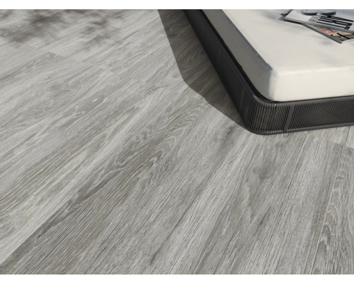 Pardoseală deschisă la culoare din lemn lângă o piesă de mobilier