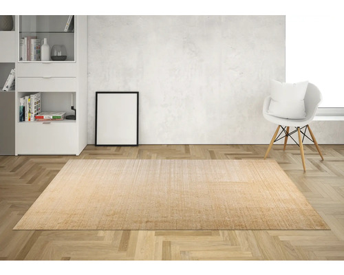 Interior cu covor bej pe podea de lemn, lângă un scaun și o comodă