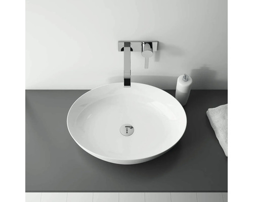 Lavoar așezat cu robinet și dispenser de săpun în baie