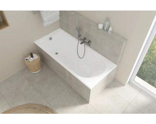 Vedere luminoasă a băii cu cadă albă, robinet și spațiu de depozitare