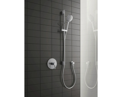 Sistem de duș cu duș de mână, bară de duș și baterie aparentă pe fundal de faianță închisă la culoare