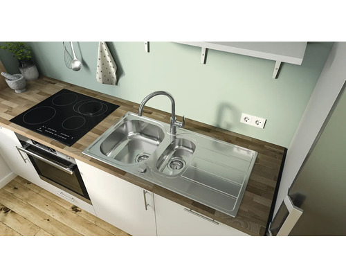 Scenă de bucătărie cu chiuvetă, robinet și plită într-o bucătărie mobilată modern.