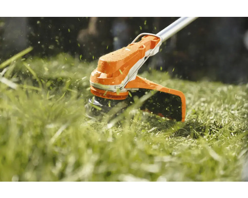 Trimmer de gazon tăind iarba