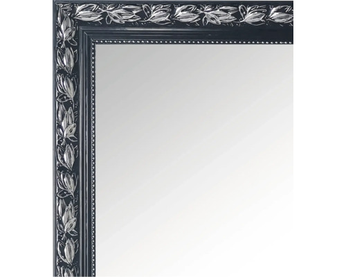 Prim-plan cu o oglindă cu ramă din lemn și motive cu frunze