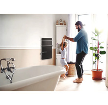 Baie cu cadă și radiator pentru prosoape, unde un tată se joacă cu copilul său