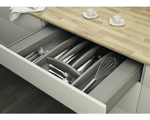 Sertar de bucătărie cu suport pentru tacâmuri și diverse piese de tacâmuri.