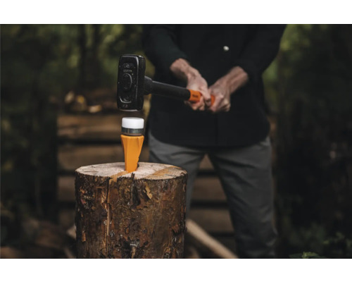 Scenă cu despicător de lemne cu ciocan pe un ciot de lemn